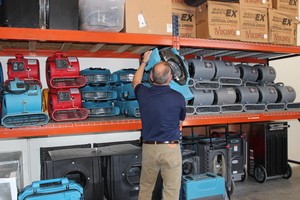 Flood Damage Restoration Technician Prepping Air Movers