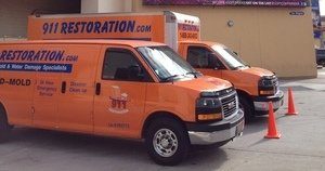 Water Damage Restoration Vans At Commerical Job Location