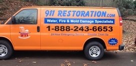 Water and Mold Damage Restoration Van At Fall Residential Job Site