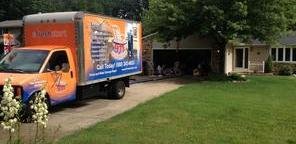 Water and Mold Damage Restoration Truck Parked Near Lawn