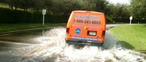 Water Damage Benbrook Van Driving Down Flooded Street